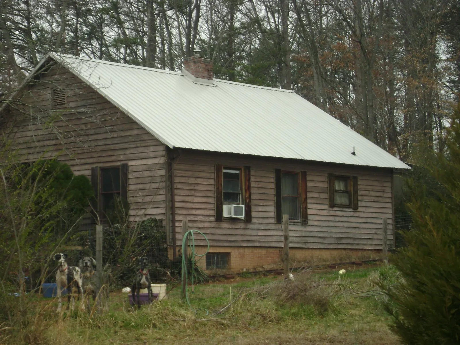 White metal roof on an old wood sided farmhouse, from a Metal Roof Installation job in Aspers